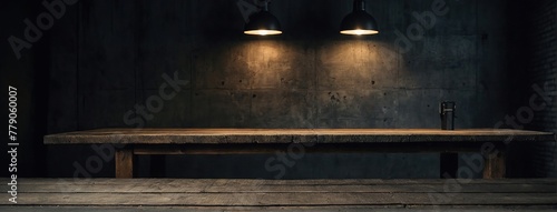 Old wood table with blurred concrete block wall in dark room background