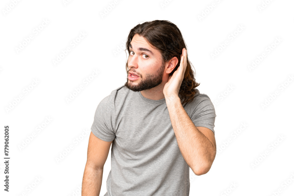 Young handsome man over isolated chroma key background listening to something by putting hand on the ear Young handsome man over isolated chroma key background listening to something by putting hand on the ear