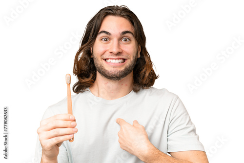 Young handsome man brushing teeth over isolated background with surprise facial expression