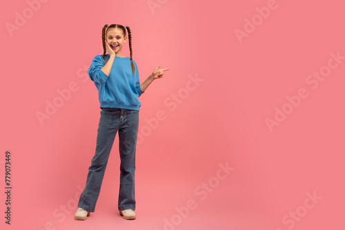 Girl posing with peace sign on pink background © Prostock-studio