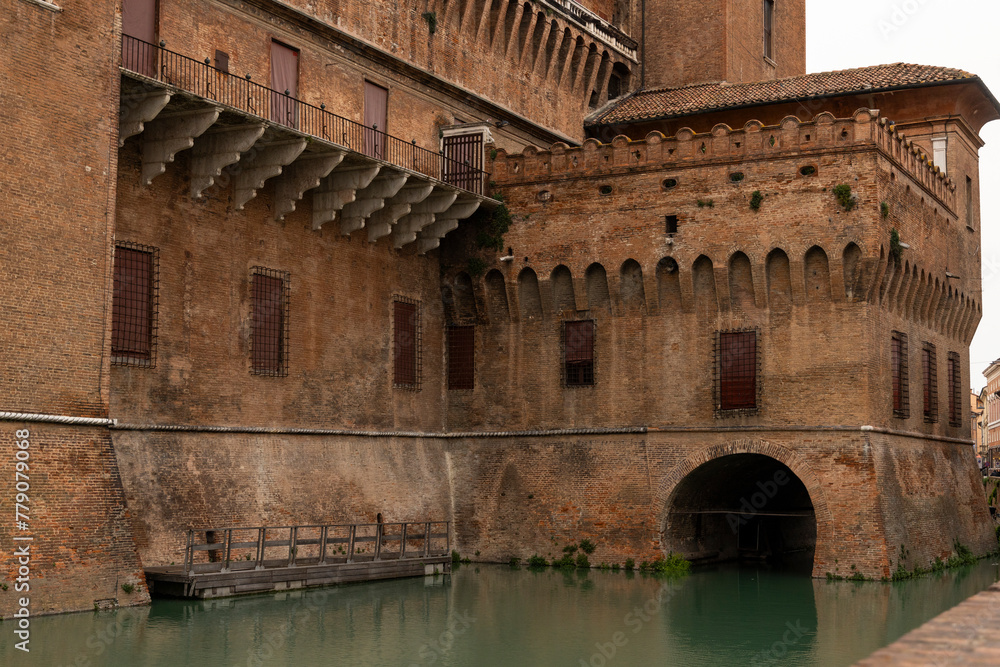 City of Ferrara, historic center, fortifications and castle surrounded by a moat. Squares and buildings in medieval style. Beautiful, unique Italian cities. World cultural heritage. Precious details.