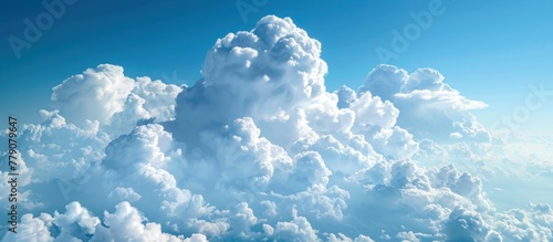 A multitude of fluffy white clouds scattered across a clear blue sky, with a large cloud dominating the scene.
