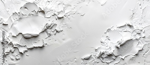 Detailed view of a white wall completely covered in thick layers of white paint, showing texture and brush strokes.