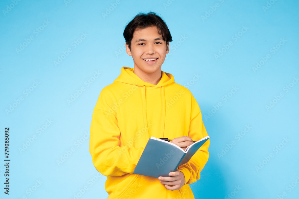 Guy reading a book, bright yellow hoodie Guy reading a book, bright yellow hoodie