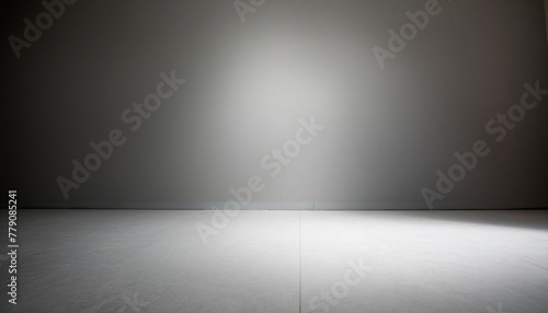 Suelo blanco y pared blanca con ilumincación de una fuente de luz puntual y sombras, degradado a negro photo