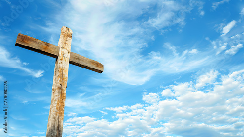 Silhouette of a wooden Christian cross against a blue sky with scattered clouds. Concept of Faith and Spirituality, Easter, Exaltation, religious holidays. Horizontal frame, copy space