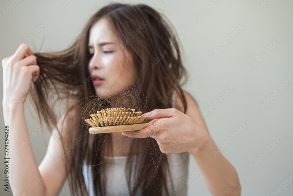 Damaged hair, amazed asian young woman, girl hand holding brush comb, hairbrush with fall hair from scalp after brushing, face worry about balding. Health care, beauty treatment, hair loss problem. Damaged hair, amazed asian young woman, girl hand holding brush comb, hairbrush with fall hair from scalp after brushing, face worry about balding. Health care, beauty treatment, hair loss problem.