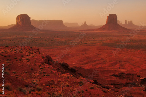 Windy, hazy sunset on the buttes and mesas of Monument Valley Navajo Tribal Park from the Artist's Point viewpoint, Arizona, USA.