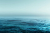 The image is of a calm, blue ocean with no visible waves