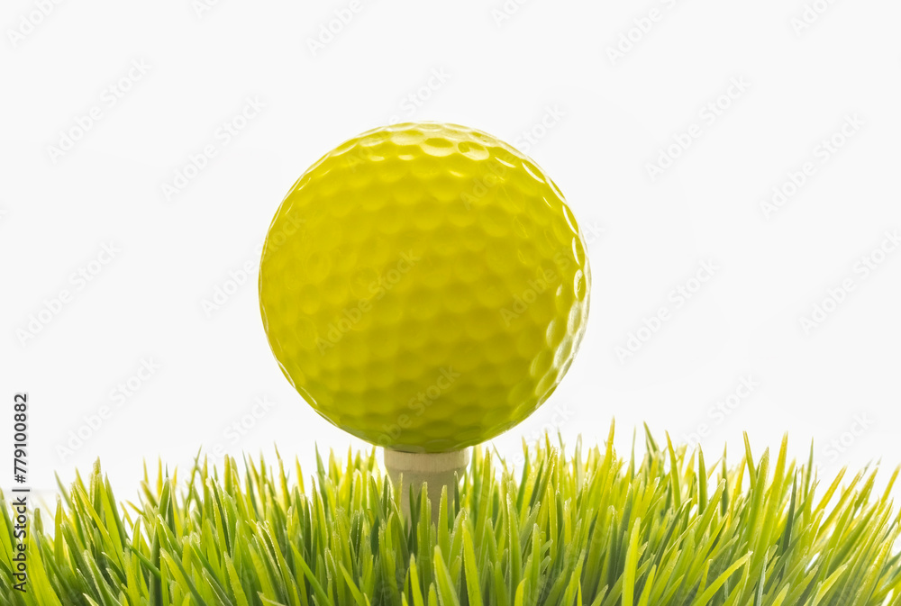 Close-up of a golf ball on tee on white background with copy space. - obrazy, fototapety, plakaty 