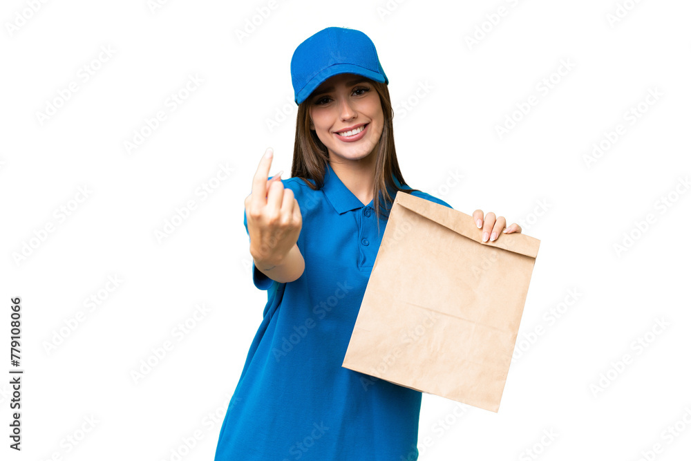Young beautiful caucasian woman taking a bag of takeaway food over isolated background doing coming gesture Young beautiful caucasian woman taking a bag of takeaway food over isolated background doing coming gesture