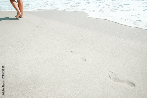 A Feet and footprints by the seashore in nature travel vacation background