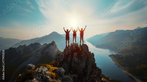 People on the top of a mountain celebrating their success, help, teamwork, leadership. Concept of meeting goals, ambition, effort and motivation in business and life. photo