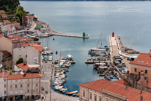 Scenic aerial view of harbor in coastal town Piran, Primorska, Slovenia, Europe. Shimmering azure waters of Adriatic Sea. Tranquil Mediterranean atmosphere. Exploring Slovenian Coast in Istria © Chris