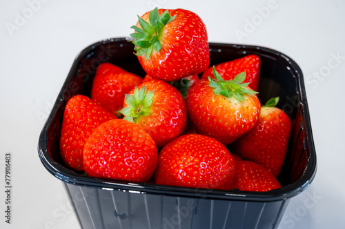 New spring harvest, one box of ripe Dutch red sweet strawberry on farmer market in the Netherlands