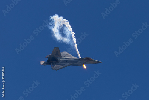 Side view of a F-22 Raptor deploying a flare