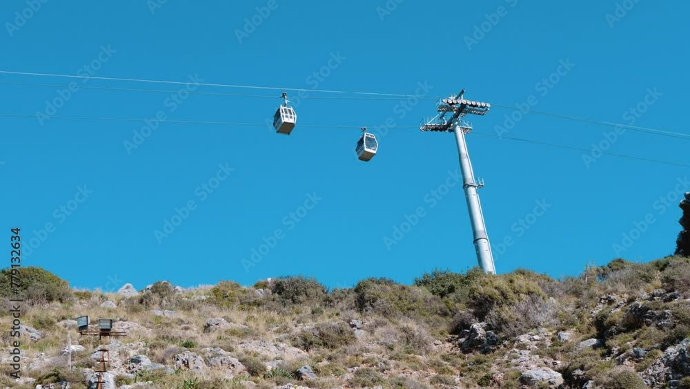 Ropeway. Funicular. Booths move against the sky Ropeway. Funicular. Booths move against the sky