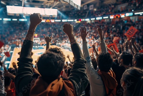 Basketball game from the perspective of the crowd, with fans cheering, waving banners, and showing support for their team