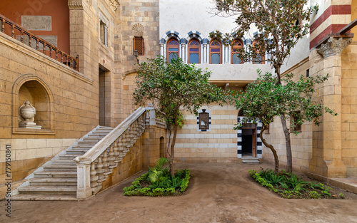 Courtyard of Prince Naguib Palace  Cairo  Egypt where lush greenery and elegant architecture create a peaceful sanctuary. The inviting staircase beckons exploration