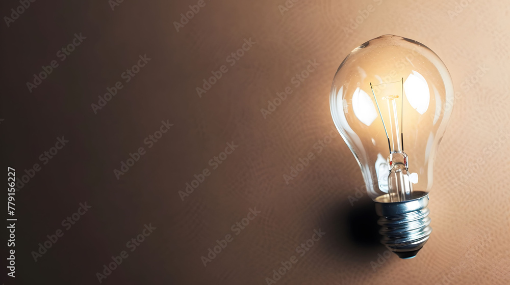glowing light bulb as a symbol of creativity, ideas and innovation on a dark earthtone gradient background with copyspace for concept text glowing light bulb as a symbol of creativity, ideas and innovation on a dark earthtone gradient background with copyspace for concept text