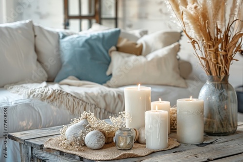 Cozy and stylish living room interior. Candles, knitted pillow cases and dried flowers.