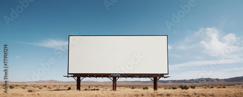 A lone, empty billboard stands tall in the vast desert landscape, surrounded by endless stretches of sand and clear blue sky.