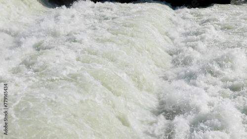 Static slow motion shot of fast flowing water on cascades of dam canal of Danube river in Dobrohost, Slovakia. photo