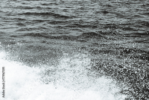 Fototapeta Naklejka Na Ścianę i Meble -  Black and white abstract background top view surface ocean wave splash creating white air foam bubble on left corner leaving negative space	