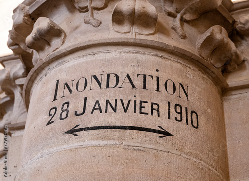 Inscription on a column meaning "Flood, 28 January 1910" marking the level of the Seine flooding in 1910, in the Conciergerie, former courthouse and prison in Paris city center, France