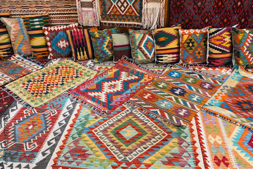 Woolen carpets and pillows with colorful oriental ornaments