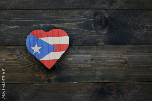 wooden heart with national flag of puerto rico on the wooden background.