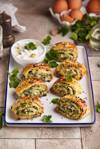 Puff pastry Pizza rolls with spinach, cheese, feta and garlic. Delicious homemade savory snack.