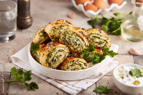 Puff pastry Pizza rolls with spinach, cheese, feta and garlic. Delicious homemade savory snack.