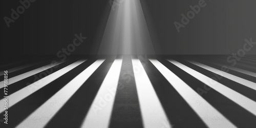 A striking black and white photo of a beam of light shining through darkness. Perfect for illustrating concepts of hope and inspiration