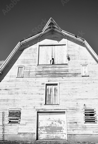 Weathered wooden farm barn under blue sky