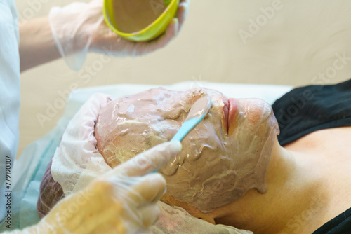 Woman Receiving Facial Mask Treatment