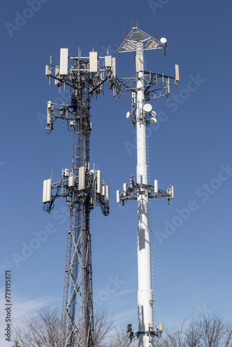 Telecommunications and wireless cell equipment tower with directional mobile phone antenna.