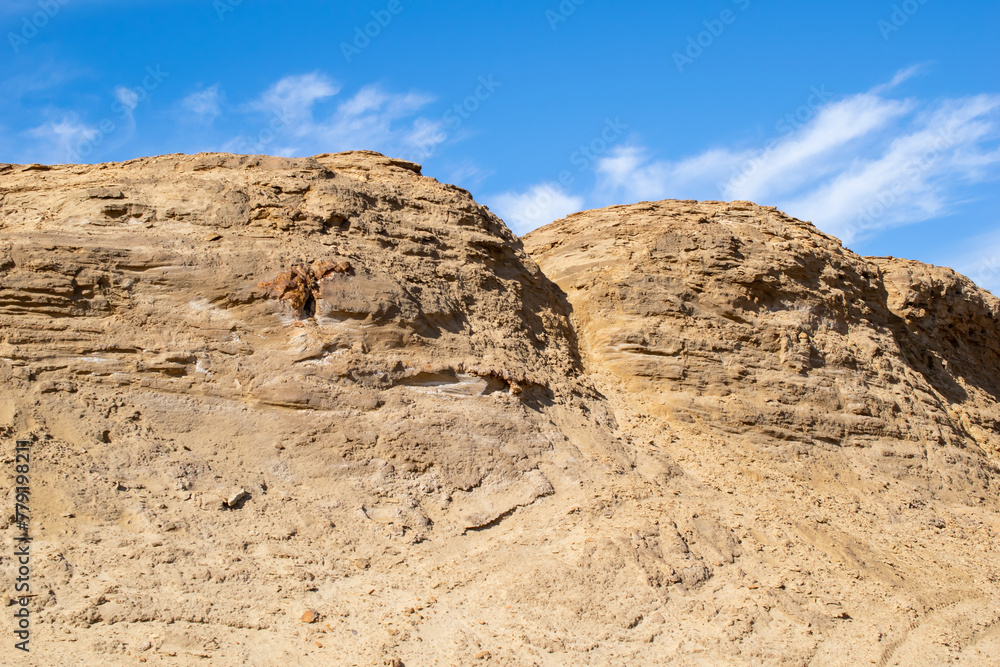 dunes of yellow sand against the sky