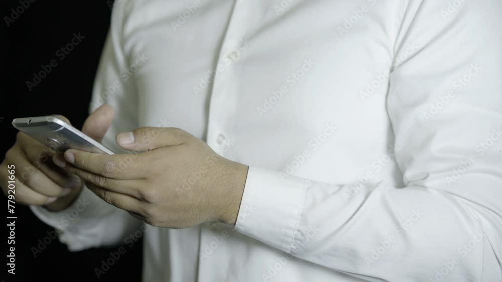 man dressed in a white shirt, sending a message on his cell phone, on a black background, cinematographic scene
man dressed in a white shirt, sending a message on his cell phone, on a black background, cinematographic scene
