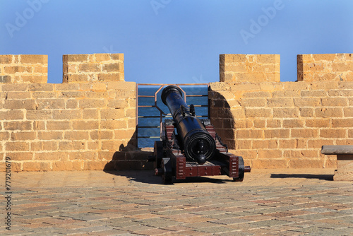 This famous tourist landmarks overlooks the sea. The old lighthouse on the famous tourist spot of fort diu. Guns Guarding historical vintage fort. built by Portuguese, located in Daman and Diu, India photo