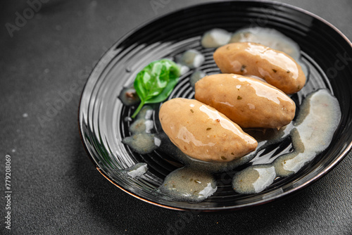 quenelles pork sauce mushroom food on a plate eating cooking appetizer meal food snack on the table copy space food background © Alesia Berlezova