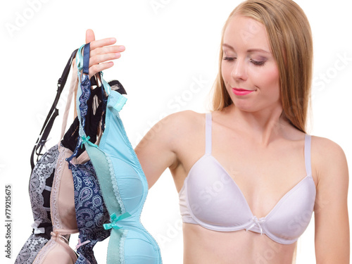 Woman holds bras, choosing photo