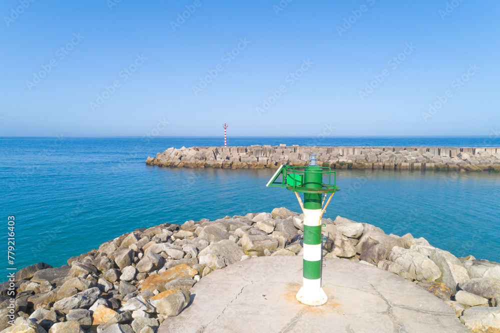 Fototapeta premium elevated view of the lanterns of a breakwater at the entrance of a port