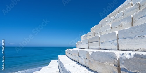 a staircase made of large white bricks against the background of the sea. a place for text  advertising