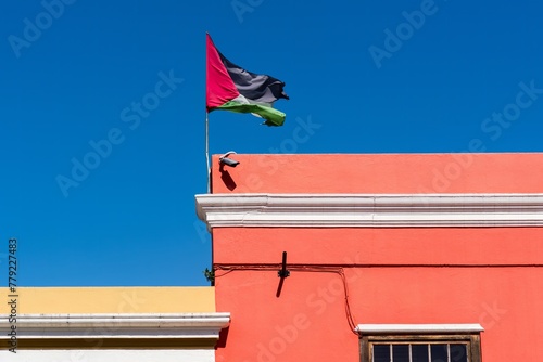 Palestine flag waving against clean blue sky