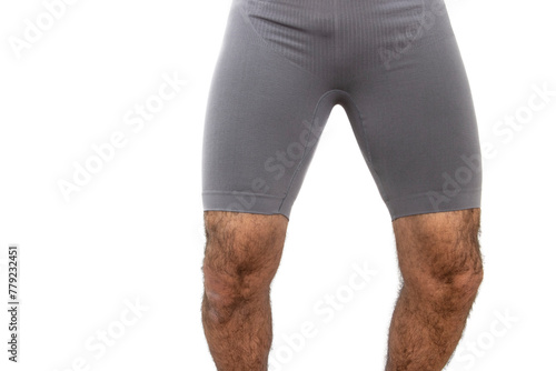 A close-up of the gray short tights, muscular and hairy legs of a mature man. Isolated in a white background. photo