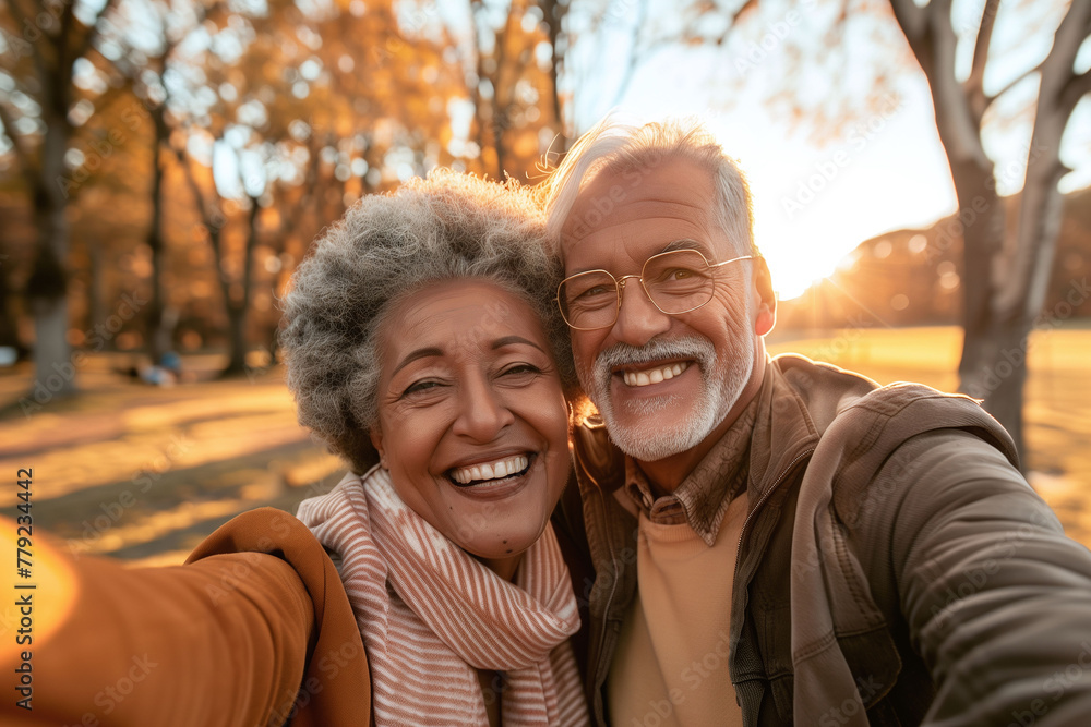 Happy Senior Couple Taking Selfie at Sunset in Park Happy Senior Couple Taking Selfie at Sunset in Park