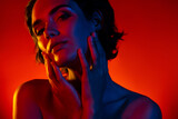 Photo of pretty sweet woman naked shoulders arms applying lifting cream empty space isolated red neon color background