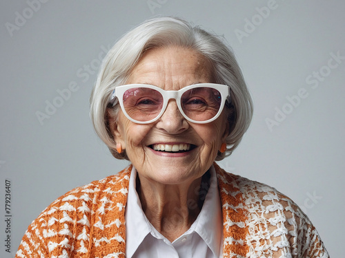 Joyful Elegance: A Smiling Elderly Woman in Large Glasses, White Background © yahya