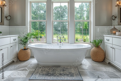 An inviting bathroom design featuring a freestanding bathtub  elegant cabinetry  and a serene natural view through large windows